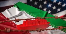 Cargo ship trapped by barbed wire with Iran and U.S. flags