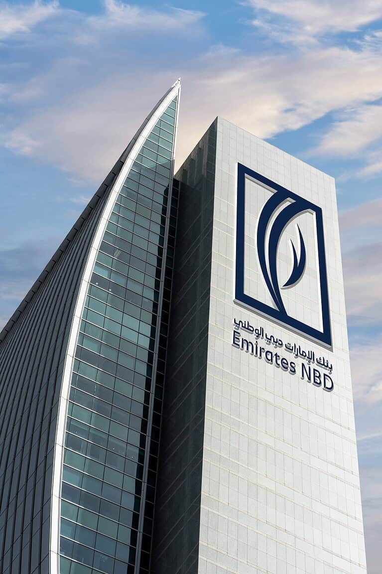 Emirates NBD Bank head office with sky and clouds in the background.