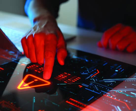 Man interacting with a holographic touchscreen interface in red color. Concept of cyber attack, malware, data breach, system hacking, virus, spyware, compromised information and urgent attention.