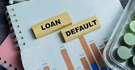 Concept of loan default text on wooden blocks.