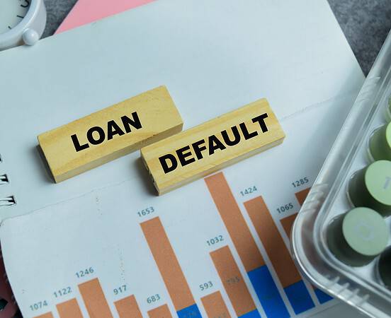 Concept of loan default text on wooden blocks.