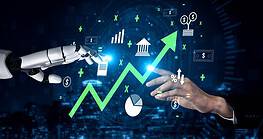 Human and robot hands pointing to a rising financial growth graph.