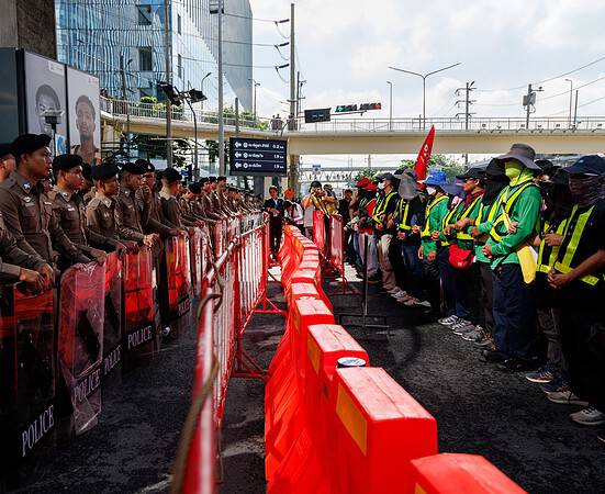 Police lines and protesters outside the IMF and World Bank annual meetings in Bangkok, Thailand.