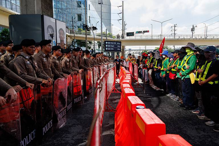 Police lines and protesters outside the IMF and World Bank annual meetings in Bangkok, Thailand.