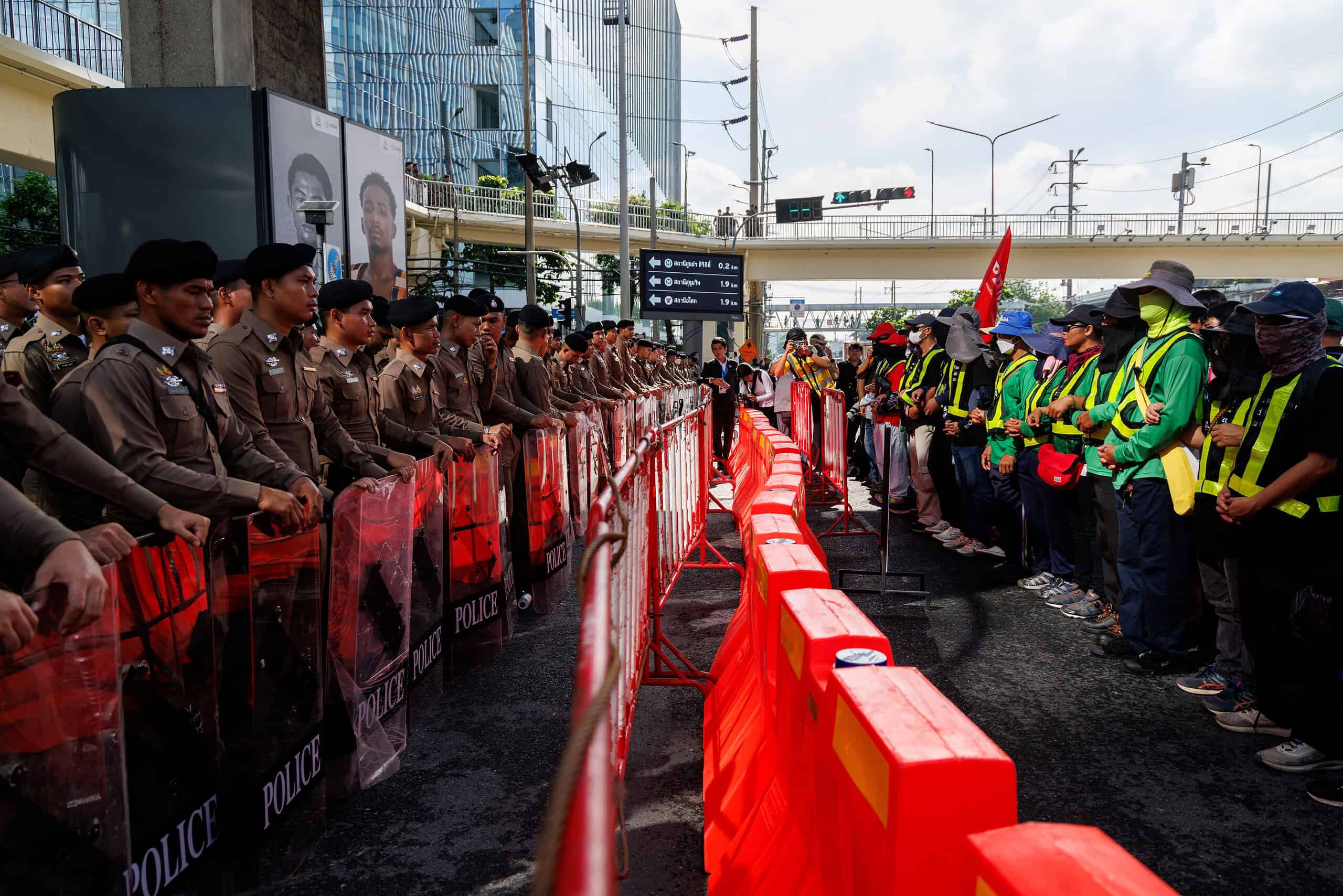 Police lines and protesters outside the IMF and World Bank annual meetings in Bangkok, Thailand.