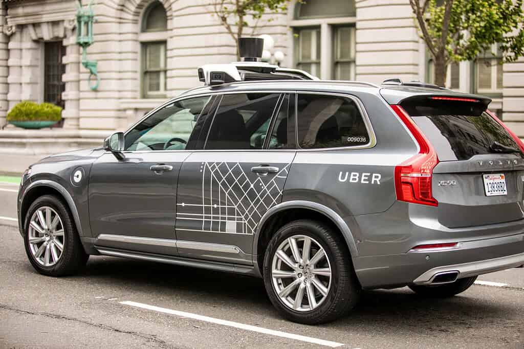 An Uber self-driving test vehicle equipped with sensor equipment navigating a San Francisco street.