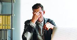 Modern man with glasses, office worker tired at work