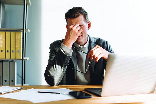 Modern man with glasses, office worker tired at work