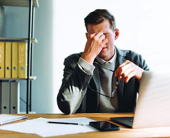 Modern man with glasses, office worker tired at work